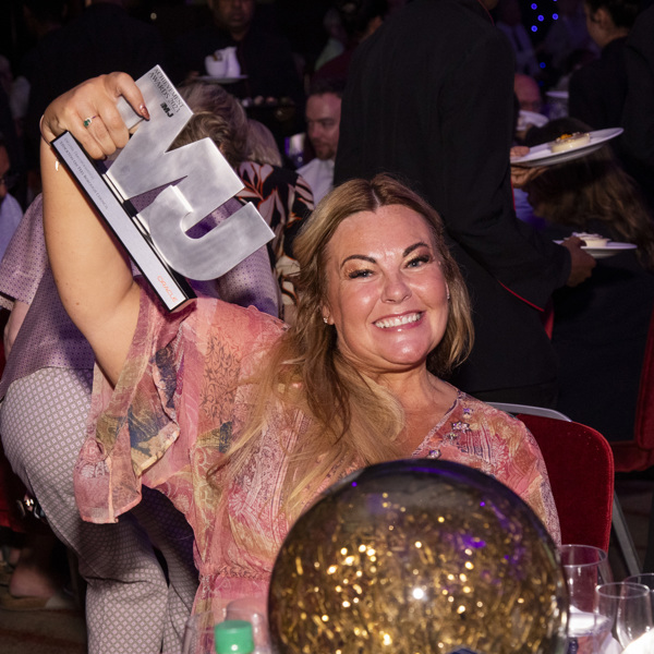 A picture of an MJ Award winner with her trophy